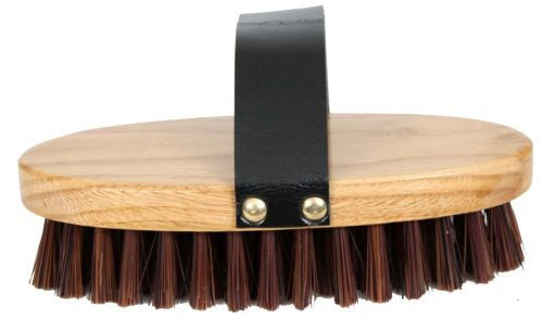 Cowboy brush. stiff bristles on an oval base with hand strap. Measures 3.5" wide and 7.5" long.