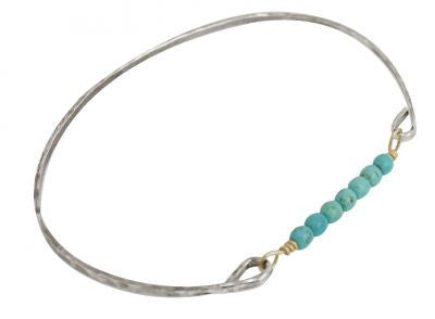 Thin silver bangle with beaded turquoise stones.